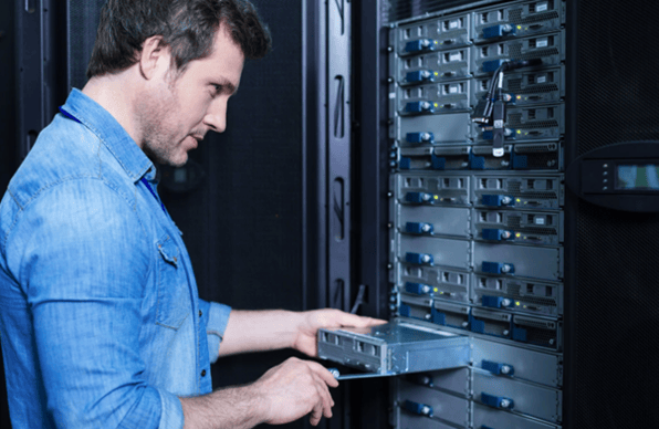 IT technician installing and maintaining server hardware as part of IT infrastructure management for engineering operations.