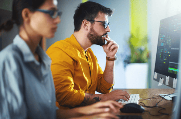 IT engineers working on systems to manage cyber security compliance services and regulatory requirements.