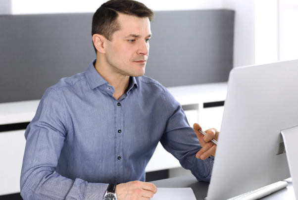 Business professional working on a desktop computer representing what are managed IT services and modern technology support solutions. 