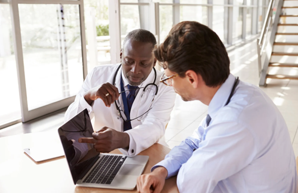 Healthcare professionals using digital systems representing healthcare IT services and secure patient data management. 
